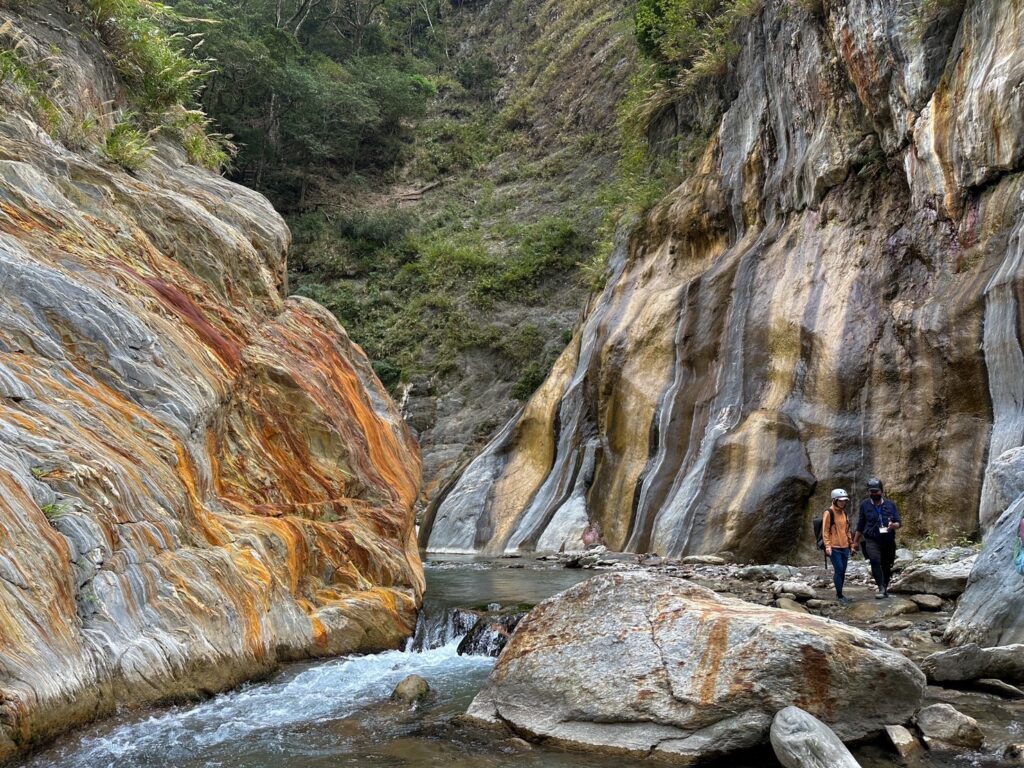 哈尤溪溫泉橘黃色的岩壁與黑黃相間的岩壁